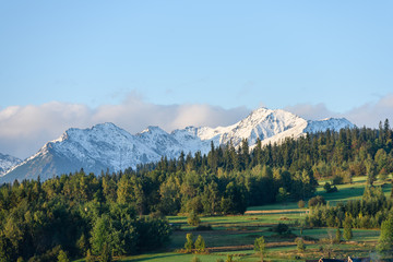 mountain tops in  autumn covered in mist or clouds in sunny day