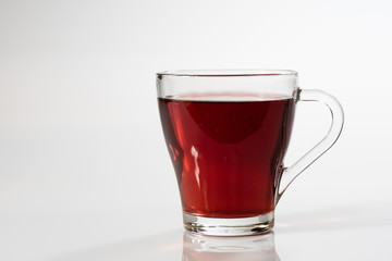 Tea in a glass on a white background. Green or fruit tea.