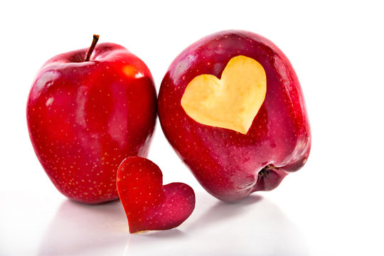 Two red apples and the cut-out heart