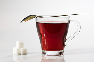 Tea in a glass on a white background. Green or fruit tea.