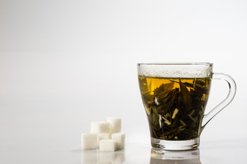 Tea in a glass on a white background. Green or fruit tea.