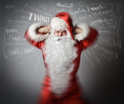 Frustrated Santa Claus and many wishes. Headache concept.