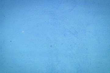 Background of a blue stucco coated and painted exterior, rough cast of cement and concrete wall texture, decorative rustic coating