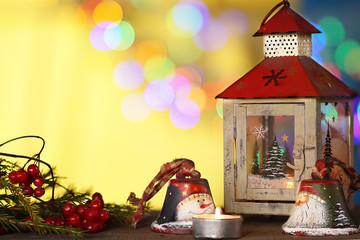 christmas decorations with candles under; colored blurred background.