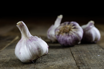 Tasty Italian garlic in an old kitchen on a wooden table