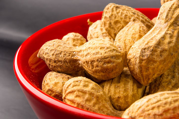 Peanuts in shell on dark background, close up