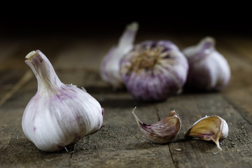 Tasty Italian garlic in an old kitchen on a wooden table