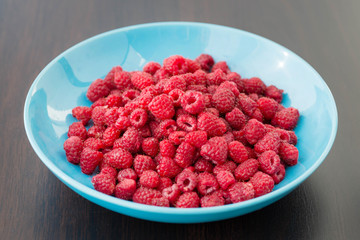 Fresh raspberries in a  plate