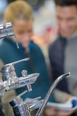 couple at furniture and faucet store choosing for home decoration