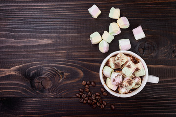 Cup of hot chocolate and marshmallow on wooden  background, top view. Christmas drink.