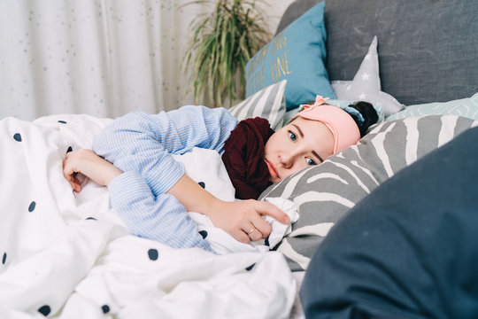 Sick Woman Is Lying In Bed With High Fever And Flu Covered With Blanket