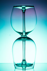 Two empty wineglass for red wine on diffusion lit background in abstract .. composition with reflection