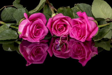 Three roses and a single pink and gold fancy ring