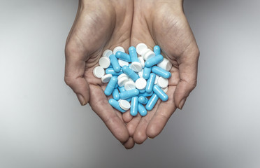 Pills in the hand. Medical preparations. Treatment of the disease