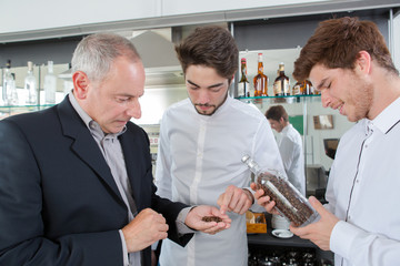 Bar staff looking at coffee beans