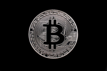Silver bitcoin (physical), macro shot, isolated on black background