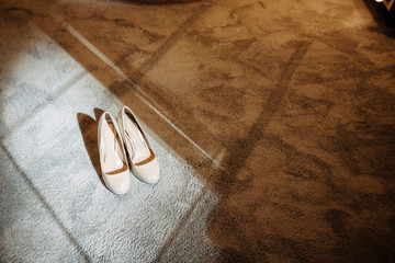 Wedding shoes on the floor in sunray