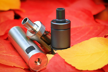 E-cigarette and autumn leaves