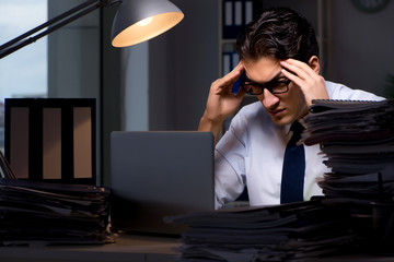Young businessman working overtime late in office