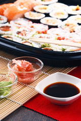 Composition with assorted sushi rolls and bowls of spices