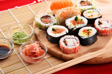 Composition with assorted sushi rolls and bowls of spices