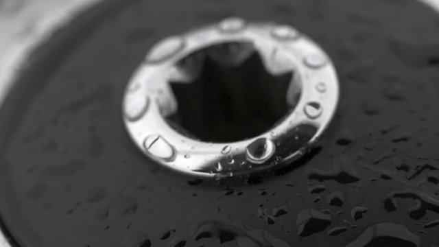 Drops water on winch slow motion. Black and white background. Marine equipment of sailing vessel. Rain on details close up.