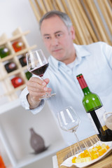 elegant man tasting wine
