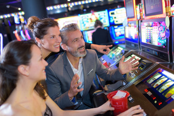 friends in casino on a slot machine