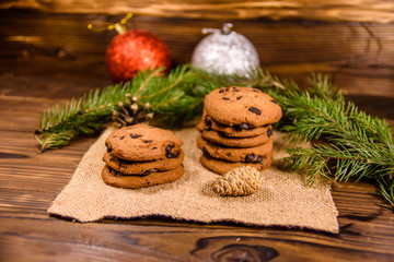 Chocolate chip cookies and christmas decorations on a wooden table