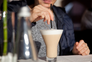 woman drinking caffe latte on terrace