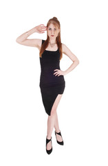 Fototapeta premium Woman standing in a black dress and heels