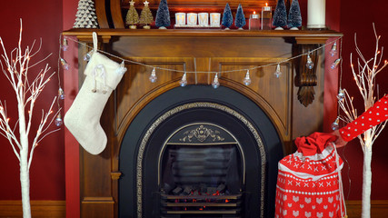 Cosy Christmas holiday decorated mantelpiece and fire place in red and white theme