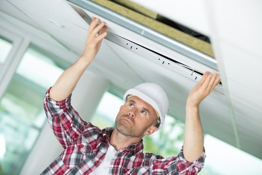 Man Holding A Gypsum Board Figured Cut