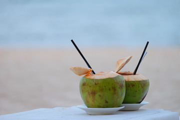 Fresh couple tropical coconuts served on the beach