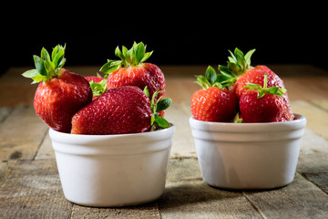 Delicious strawberries in a homemade kitchen on a wooden table