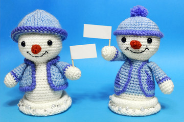 Two snowmen holding placards