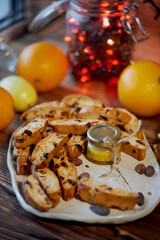 Cookie biscotti, a jar of honey and fruit. The atmosphere of warmth and coziness. New year atmosphere