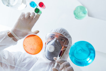 Fototapeta premium Chemist working in the laboratory with hazardous chemicals 