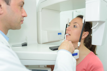 Obraz premium male dentist and female patient in dental office