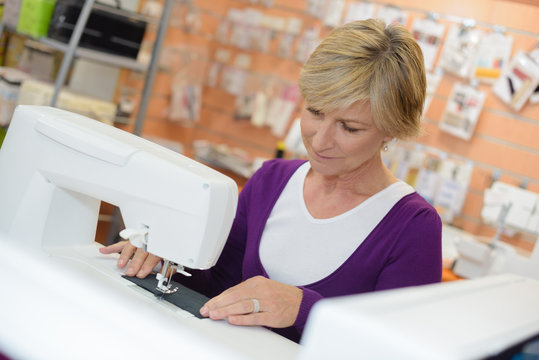 Senior lady using sewing machine