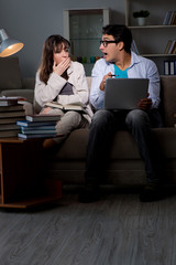 Two students studying late preparing for exams