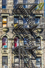 iron fire ladder at the facade of an old historic house in New York
