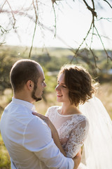 Young Bride and Groom couple in garden. Love and tenderness - 183247084