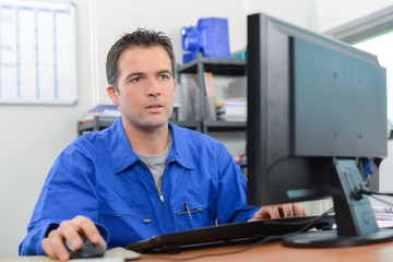 Manual worker sat at his desk