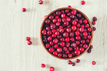 fresh cranberries on white wooden surface