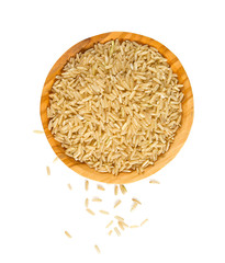 brown rice in a olive wood bowl isolated on white