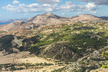 Fototapeta na wymiar Stony landscape of Tsambika mountain, it is overgrown with wood. Rhodes Island, Greece.