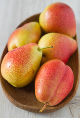 beautiful ripe pears on wooden surface