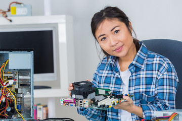 woman fixing a computer at work