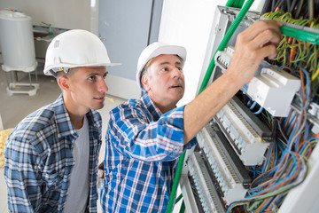 tradesmen installing a distribution board